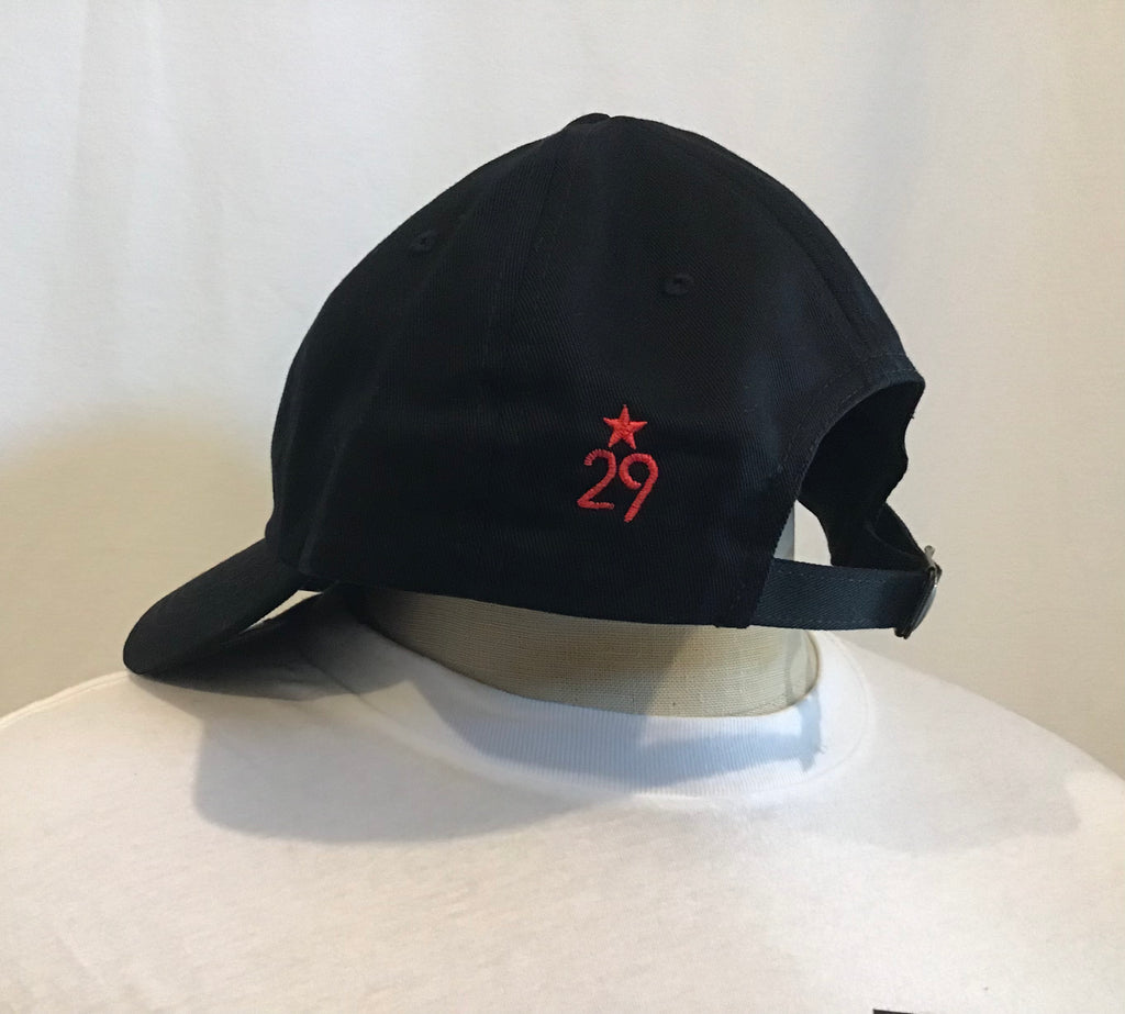 Side view of all black dad hat with red 29th state apparel logo on back left panel in red