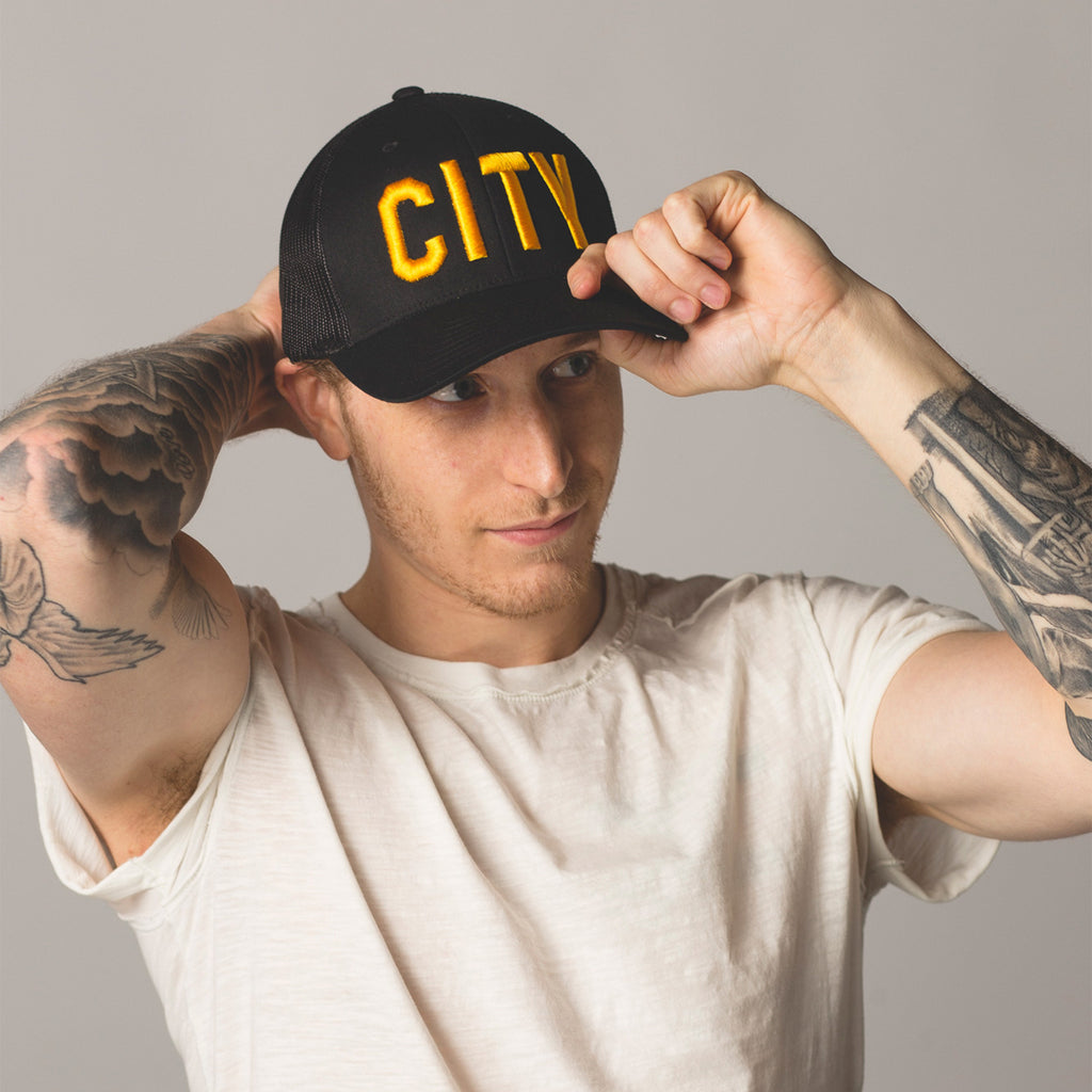 alt front view on model CITY Trucker Hat black