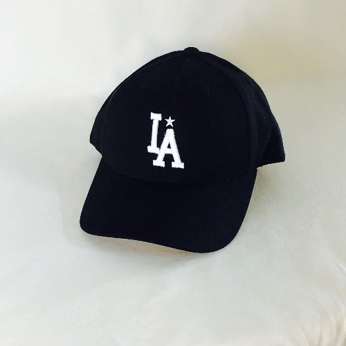 All black wool blend five-panel hat with a mid-profile structured fit. "IA" embroidered on front center descending toward the brim with a small star above the "a"