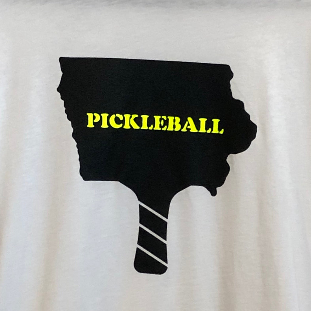a closeup photo of a t-shirt design featuing the outline of iowa in the shape of a pickleball paddle all in black and in neon yellow "pickleball" in the paddle