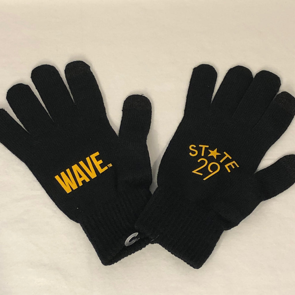 a large pair of black knit gloved with wave trademarked printed in gold on one side and the 29th state apparel logo on the second side