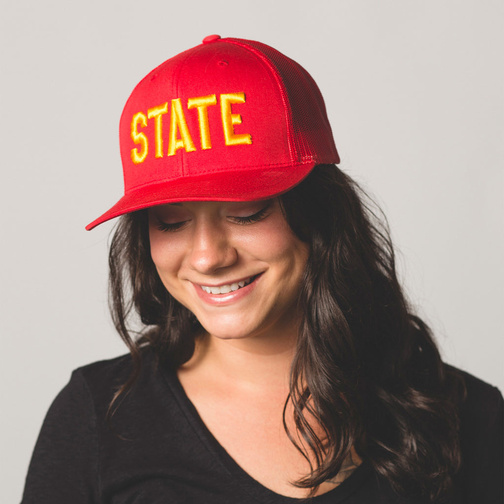 Front view on model of red state hat gold letters