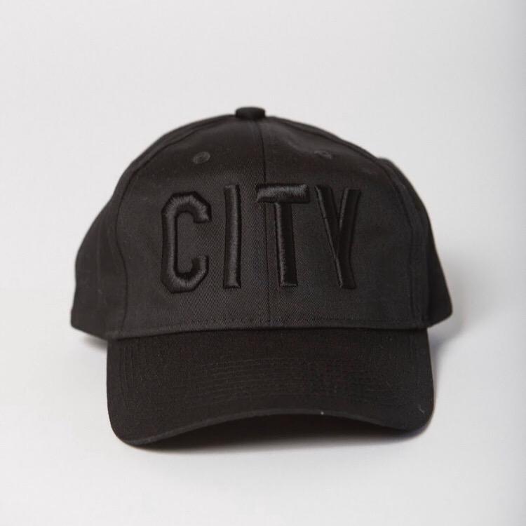 front view of black baseball hat with black CITY embroidered on the front