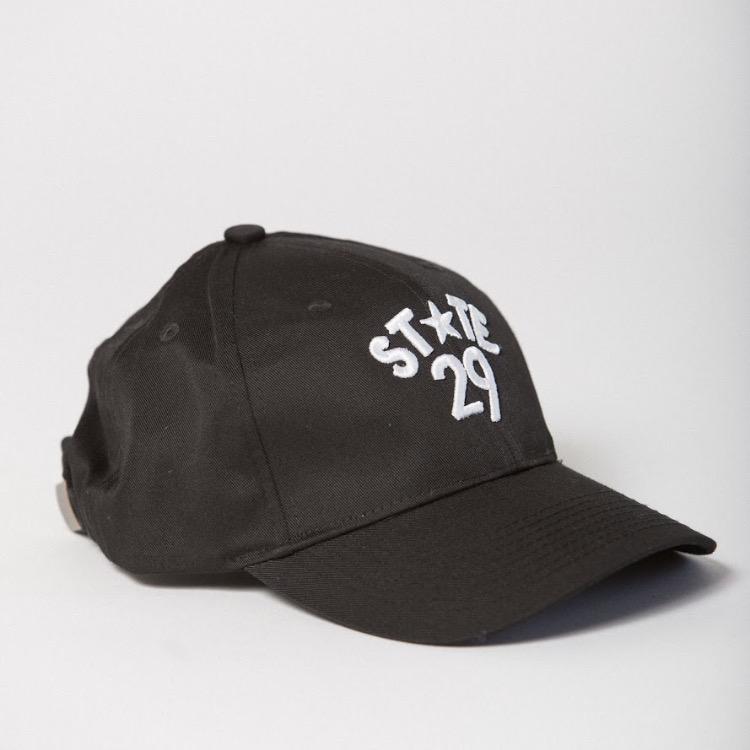 side view of black baseball hat with 29th state apparel logo in white embroidered on the front